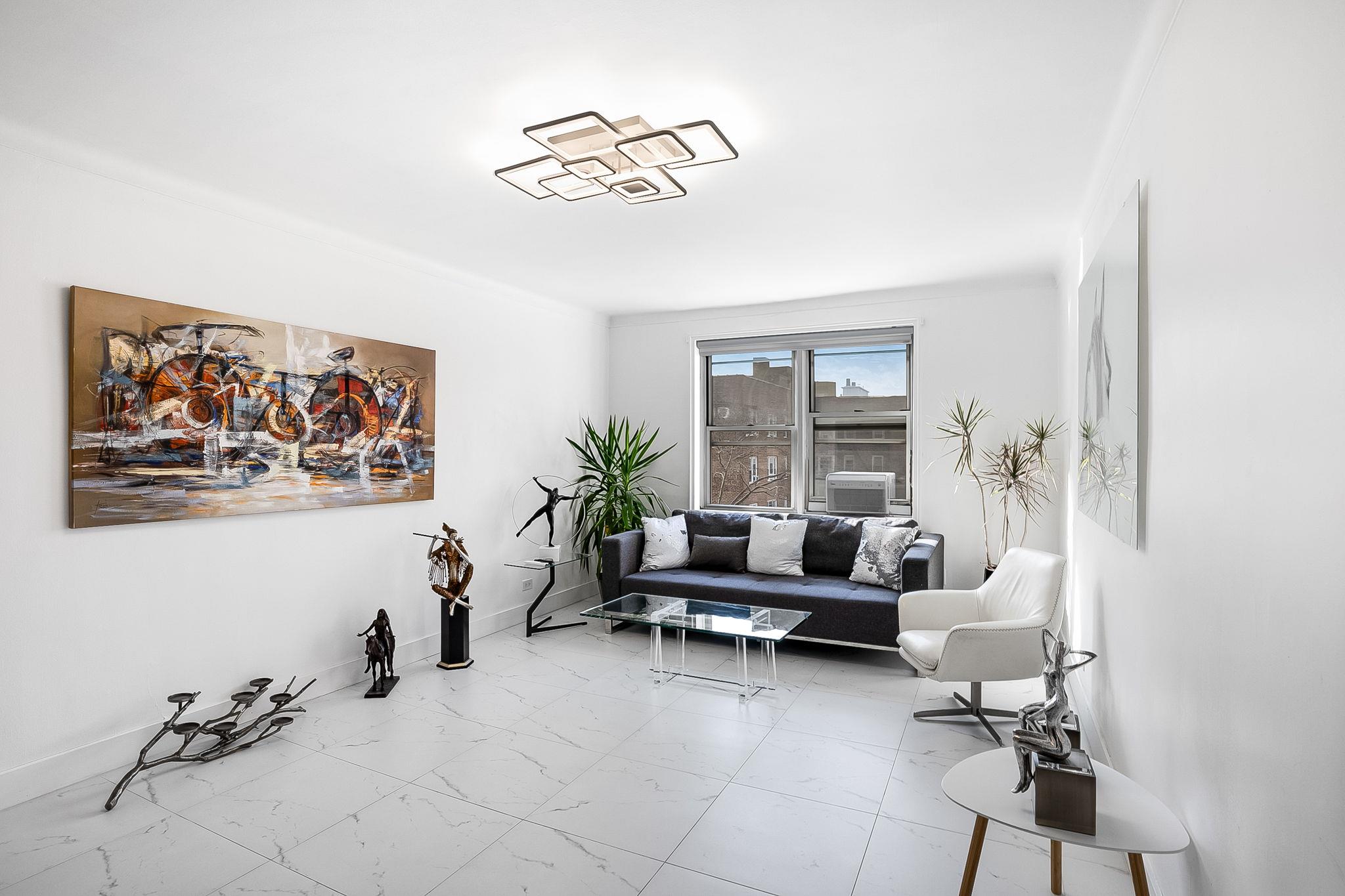 99-31 64th Avenue, Unit E10 Queens, NY 11374 - Photo 2 of 14 a living room with furniture and a large window