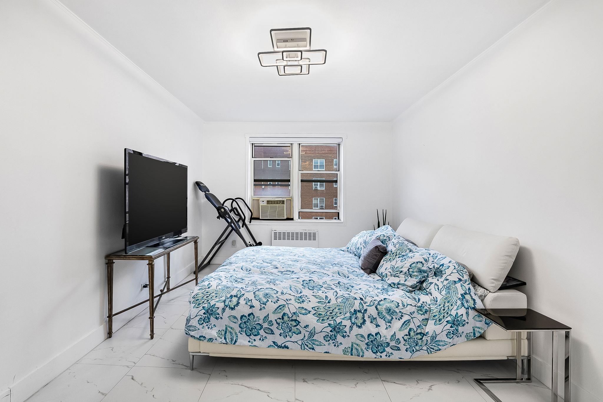 99-31 64th Avenue, Unit E10 Queens, NY 11374 - Photo 8 of 14 Bedroom with cooling unit and radiator