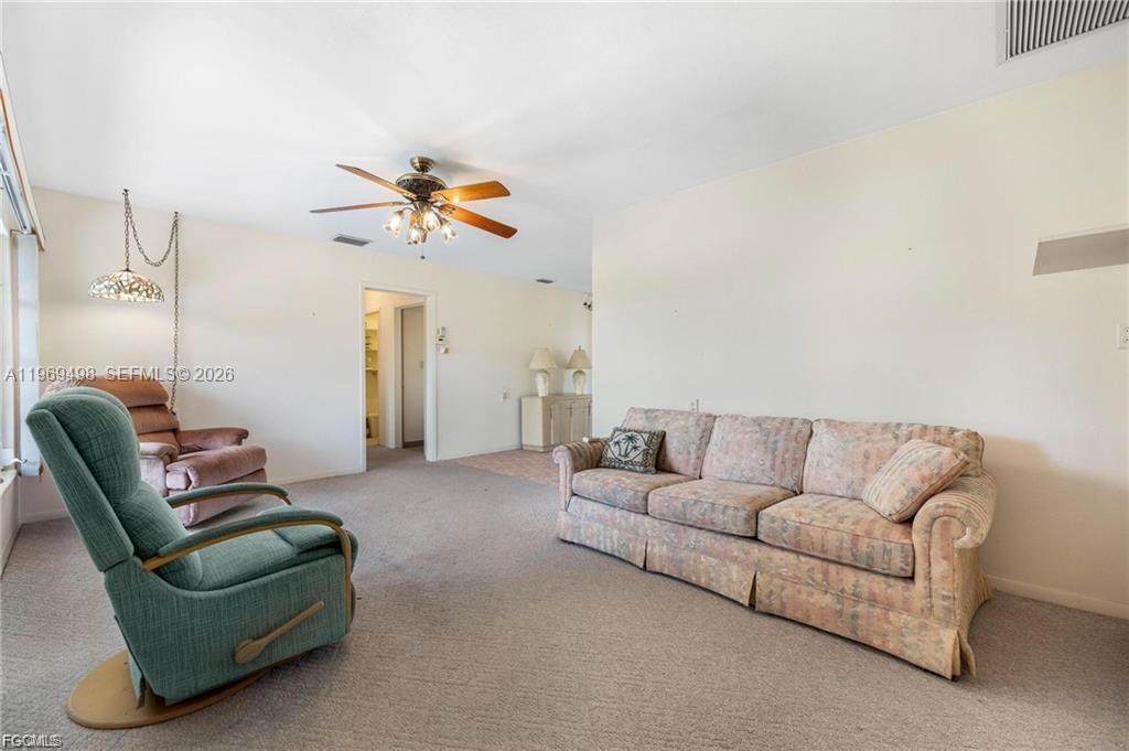 2030 Fort Denaud Road LaBelle, FL 33935 - Photo 11 of 25 a living room with furniture and a chandelier