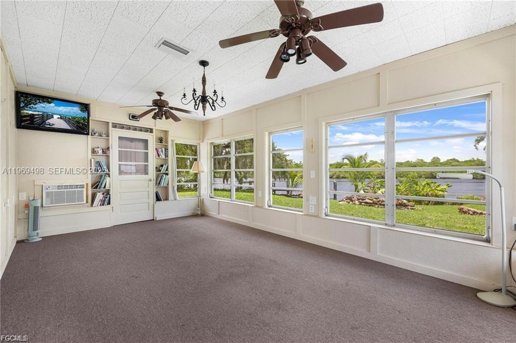 2030 Fort Denaud Road LaBelle, FL 33935 - Photo 12 of 25 a view of a livingroom with furniture ceiling fan and window