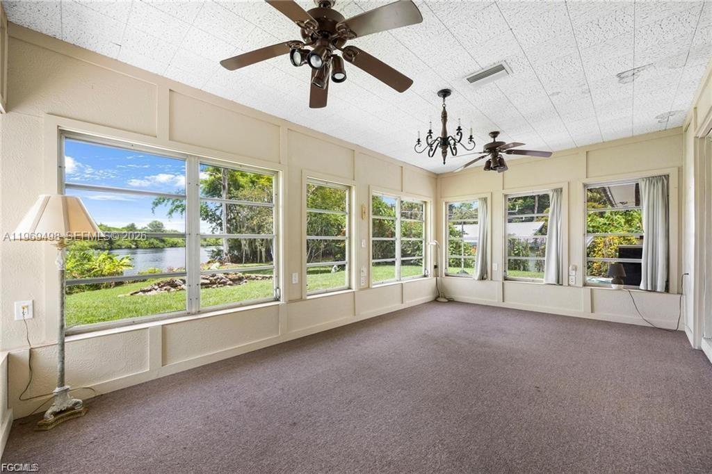 2030 Fort Denaud Road LaBelle, FL 33935 - Photo 13 of 25 a view of a livingroom with a ceiling fan and window
