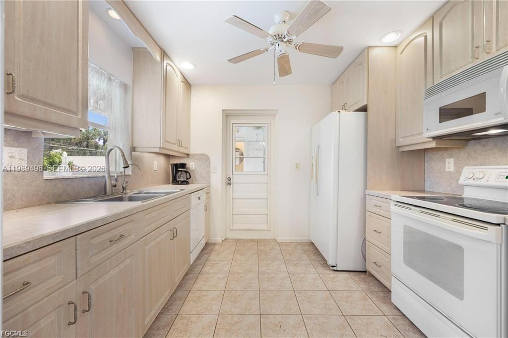 2030 Fort Denaud Road LaBelle, FL 33935 - Photo 15 of 25 a large white kitchen with cabinets
