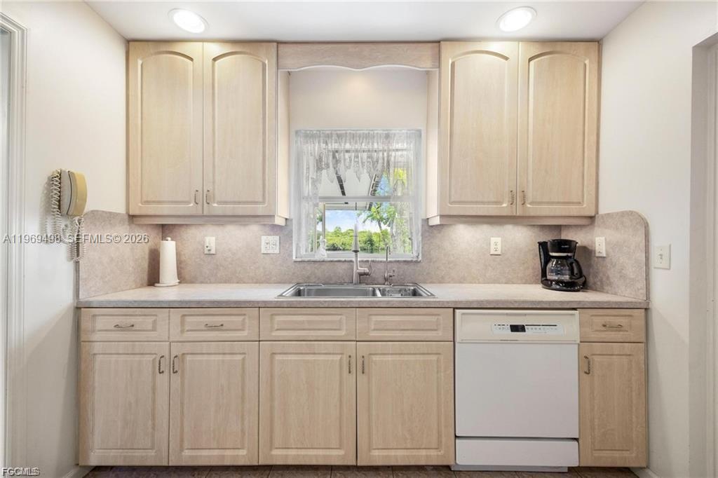 2030 Fort Denaud Road LaBelle, FL 33935 - Photo 16 of 25 a kitchen with white cabinets and a window