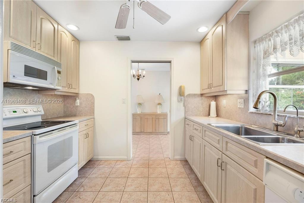 2030 Fort Denaud Road LaBelle, FL 33935 - Photo 17 of 25 a kitchen with white cabinets and appliances