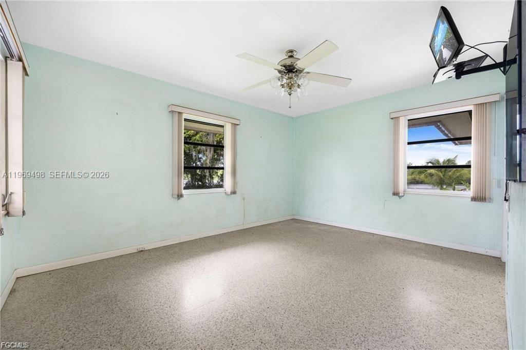2030 Fort Denaud Road LaBelle, FL 33935 - Photo 19 of 25 an empty room with windows and fan