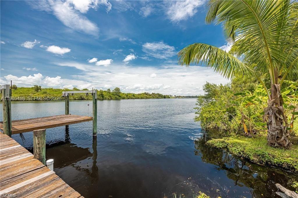 2030 Fort Denaud Road LaBelle, FL 33935 - Photo 7 of 25 a view of a lake with couches and wooden floor