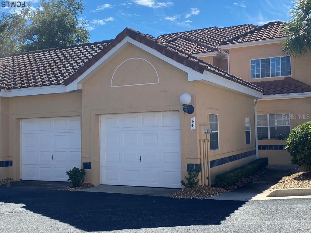 44 Captains Walk, Unit 44 Palm Coast, FL 32137 - Photo 1 of 1 a front view of a house with garden