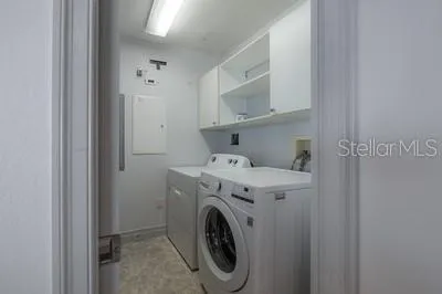 a kitchen with stainless steel appliances granite countertop a sink a refrigerator and a granite counter tops with a window