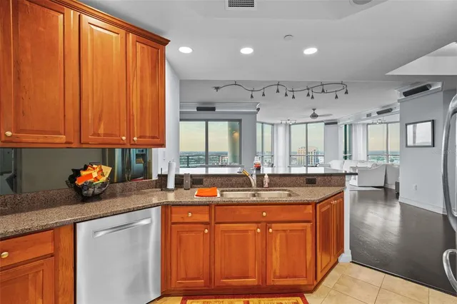 a kitchen with stainless steel appliances granite countertop a sink stove and cabinets