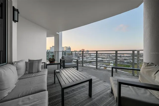 a living room with furniture and a floor to ceiling window