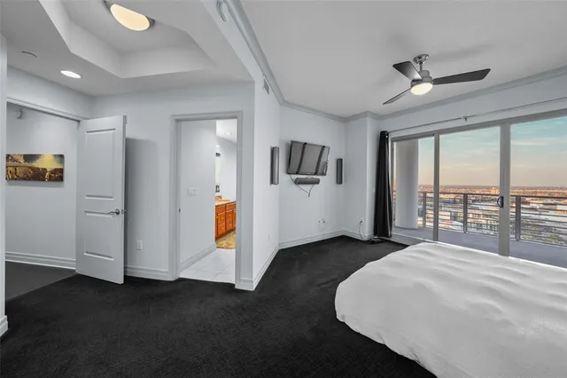 a bedroom with a bed and a large window