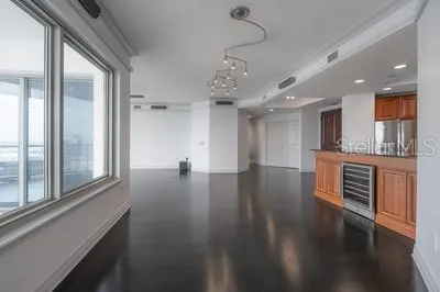 a kitchen with stainless steel appliances granite countertop a sink and a refrigerator