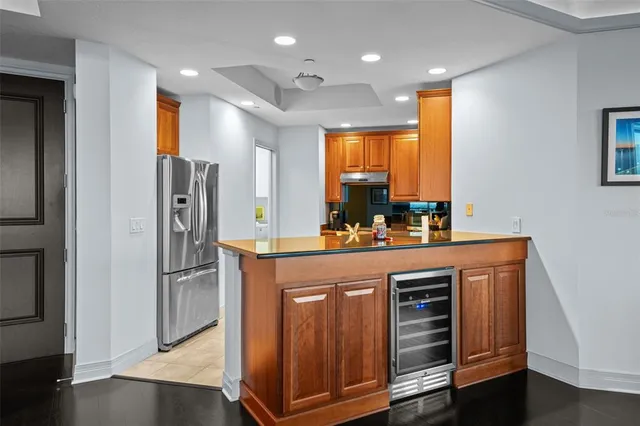 a kitchen with stainless steel appliances granite countertop a refrigerator and a stove