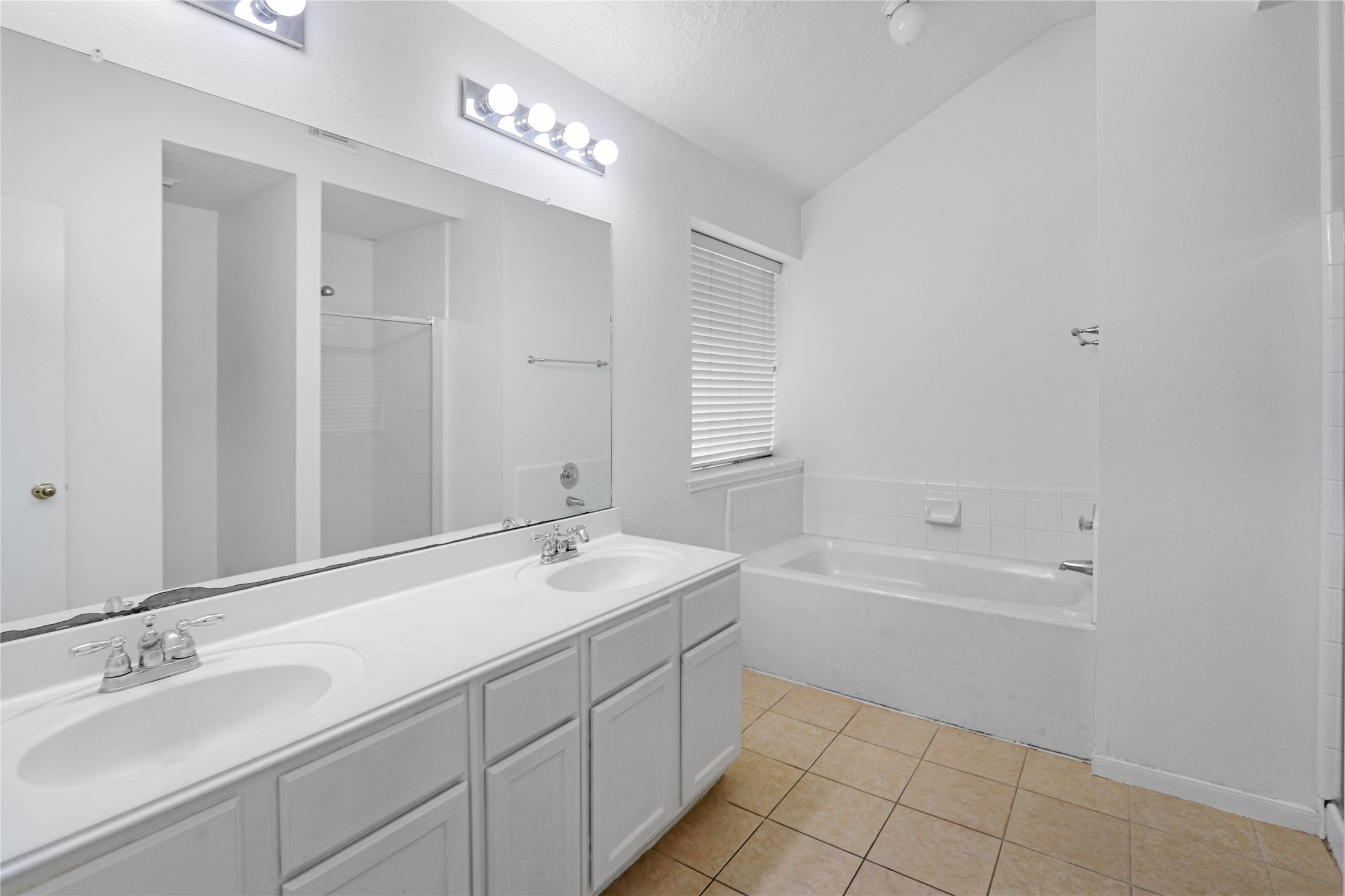 3226 Mourning Dove Drive Spring, TX 77388 - Photo 13 of 17 a spacious bathroom with a bathtub sink double and mirror