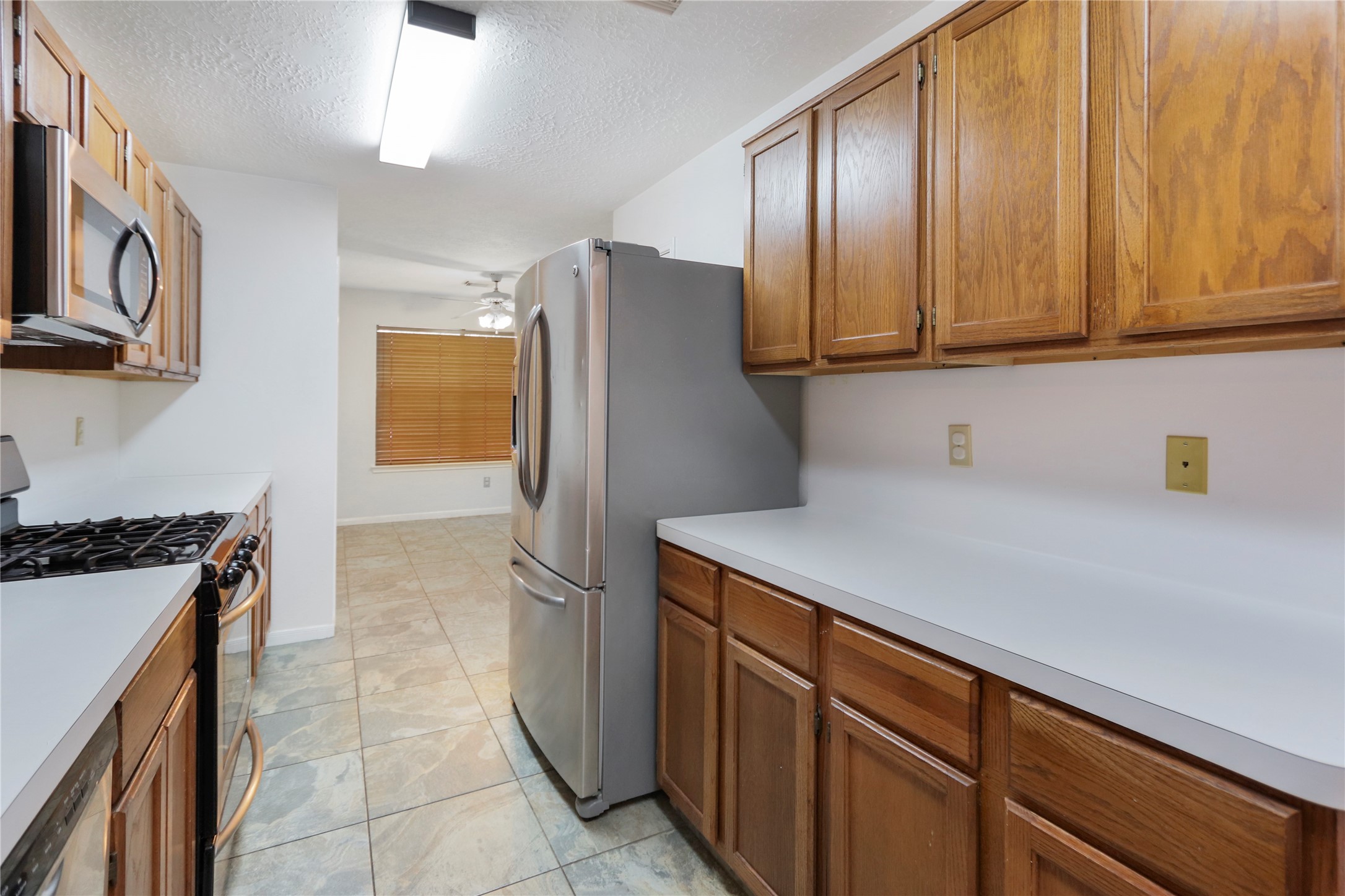 3226 Mourning Dove Drive Spring, TX 77388 - Photo 5 of 17 a kitchen with stainless steel appliances granite countertop a refrigerator and a stove top oven