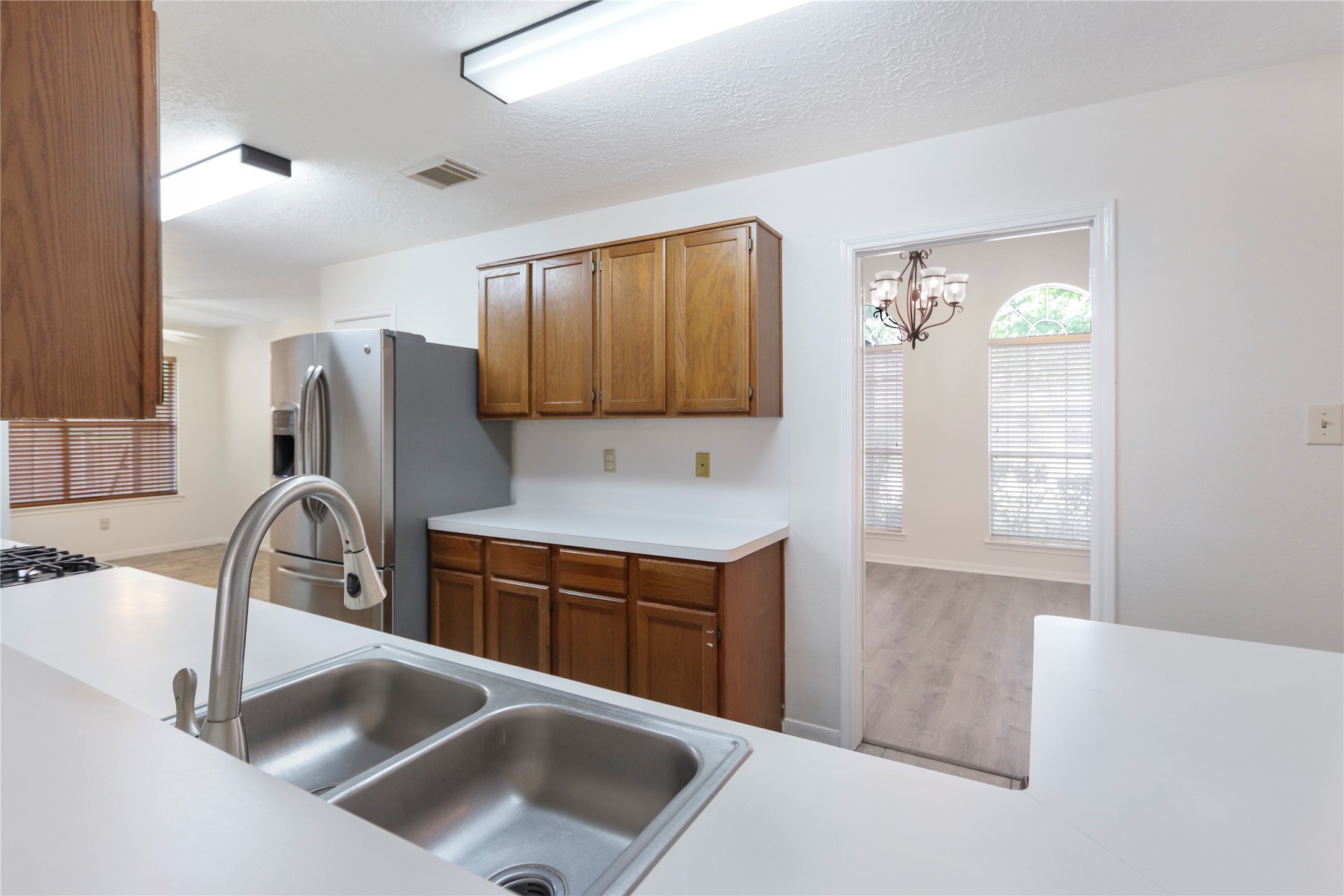 3226 Mourning Dove Drive Spring, TX 77388 - Photo 6 of 17 a kitchen with stainless steel appliances granite countertop a sink stove and refrigerator