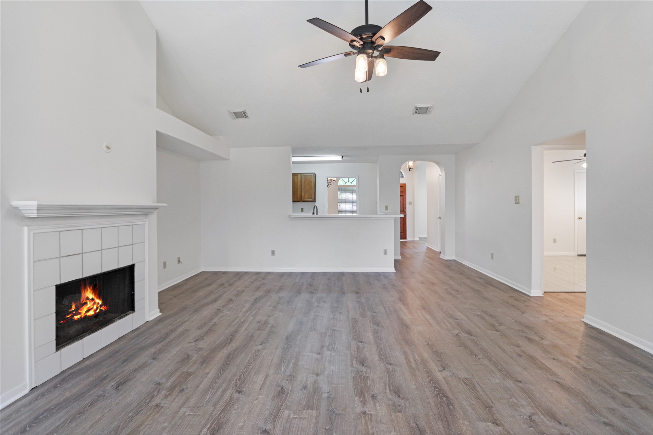 3226 Mourning Dove Drive Spring, TX 77388 - Photo 10 of 17 an empty room with wooden floor a fireplace and windows