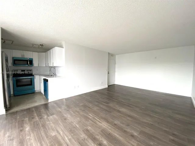a view of kitchen with wooden floor