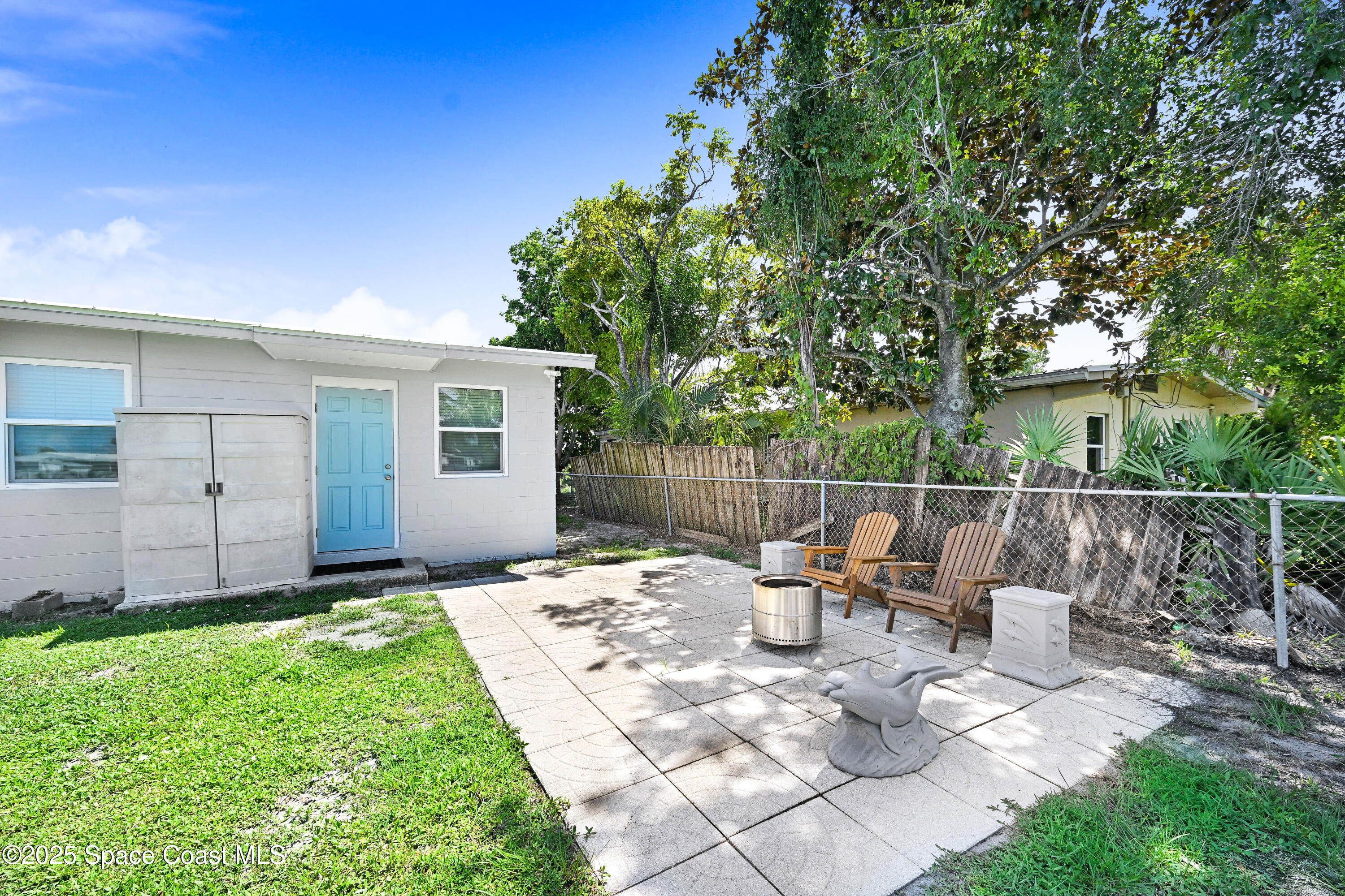 702 Lund Circle Melbourne, FL 32901 - Photo 24 of 28 a view of a chair and table in backyard of the house