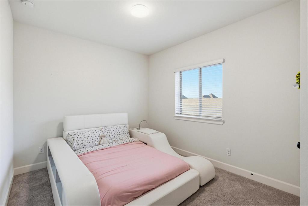 9341 Loggerhead Way Fort Worth, TX 76118 - Photo 27 of 35 Bright room featuring a window with horizontal blinds, neutral wall paint, and gray carpet flooring