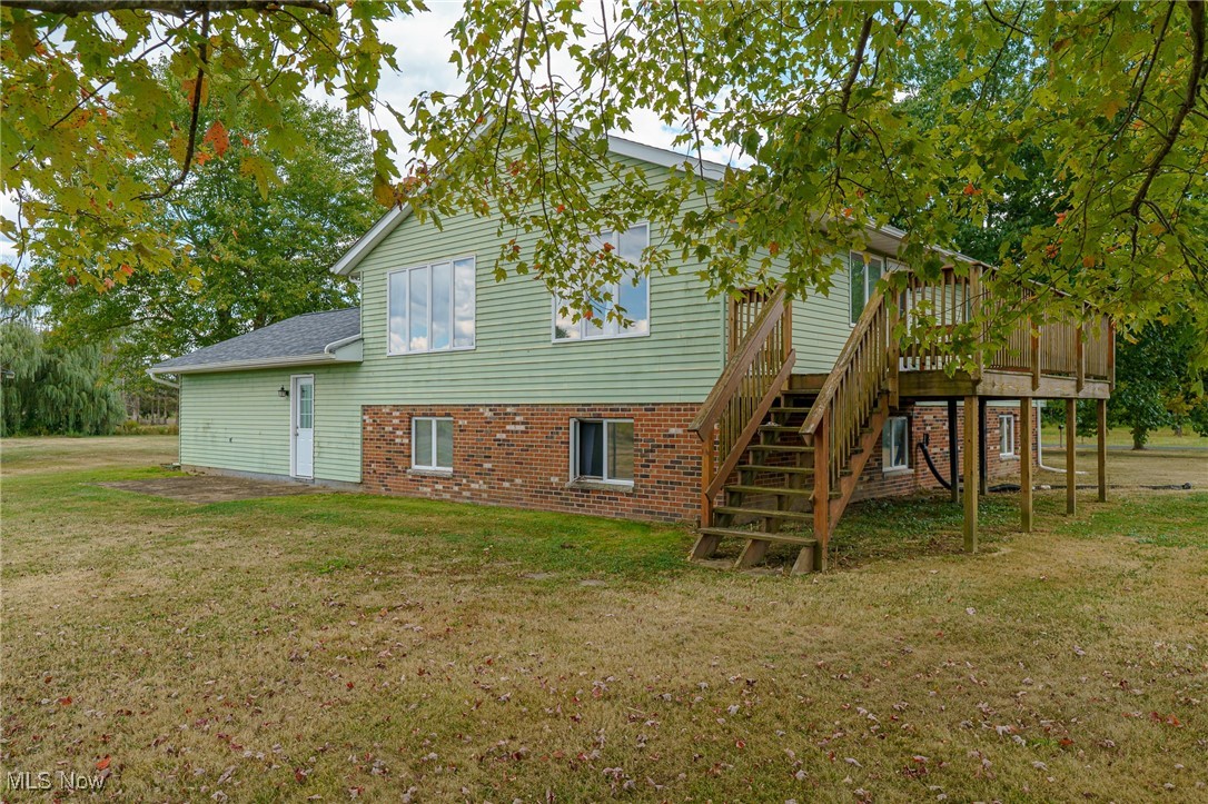 6747 Giddings Road Rootstown, OH 44272 - Photo 27 of 39 View of back of home with steps going up to wood deck