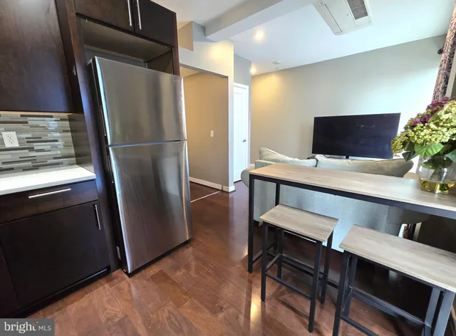 a kitchen with a table and refrigerator