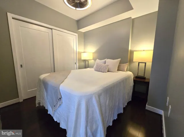 a bedroom with a bed and a lamp