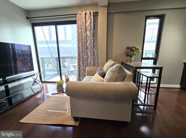 a living room with furniture and a window