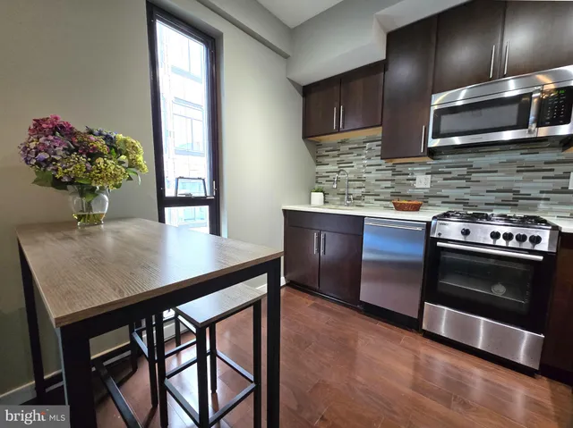 a kitchen with a stove cabinets and microwave