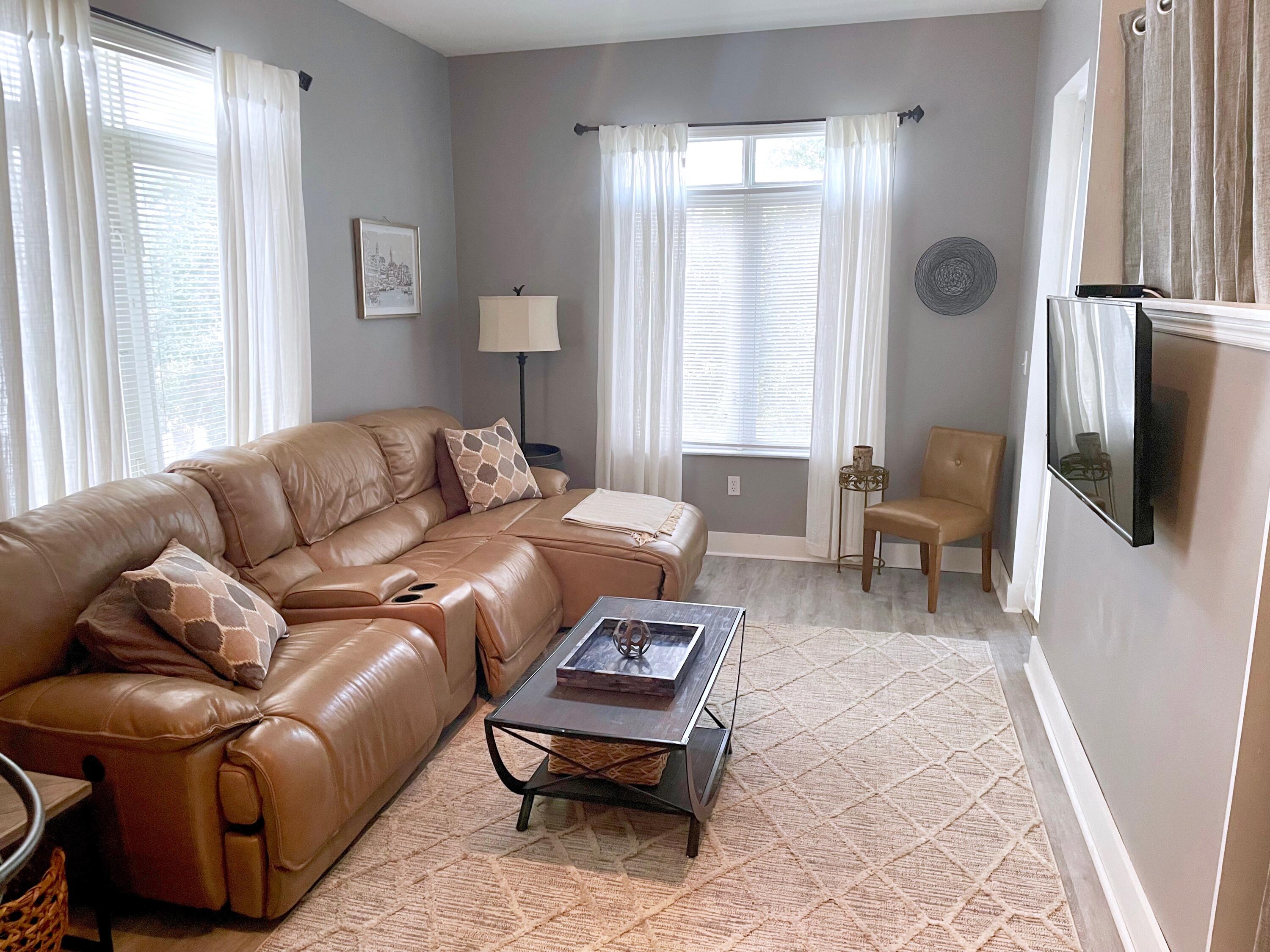 1209 Main Street, Unit 209 Jupiter, FL 33458 - Photo 3 of 14 a living room with furniture and a window