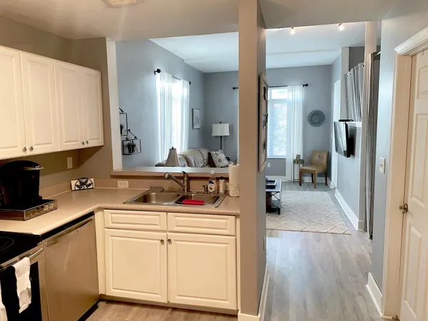 a kitchen with a sink stove and cabinets