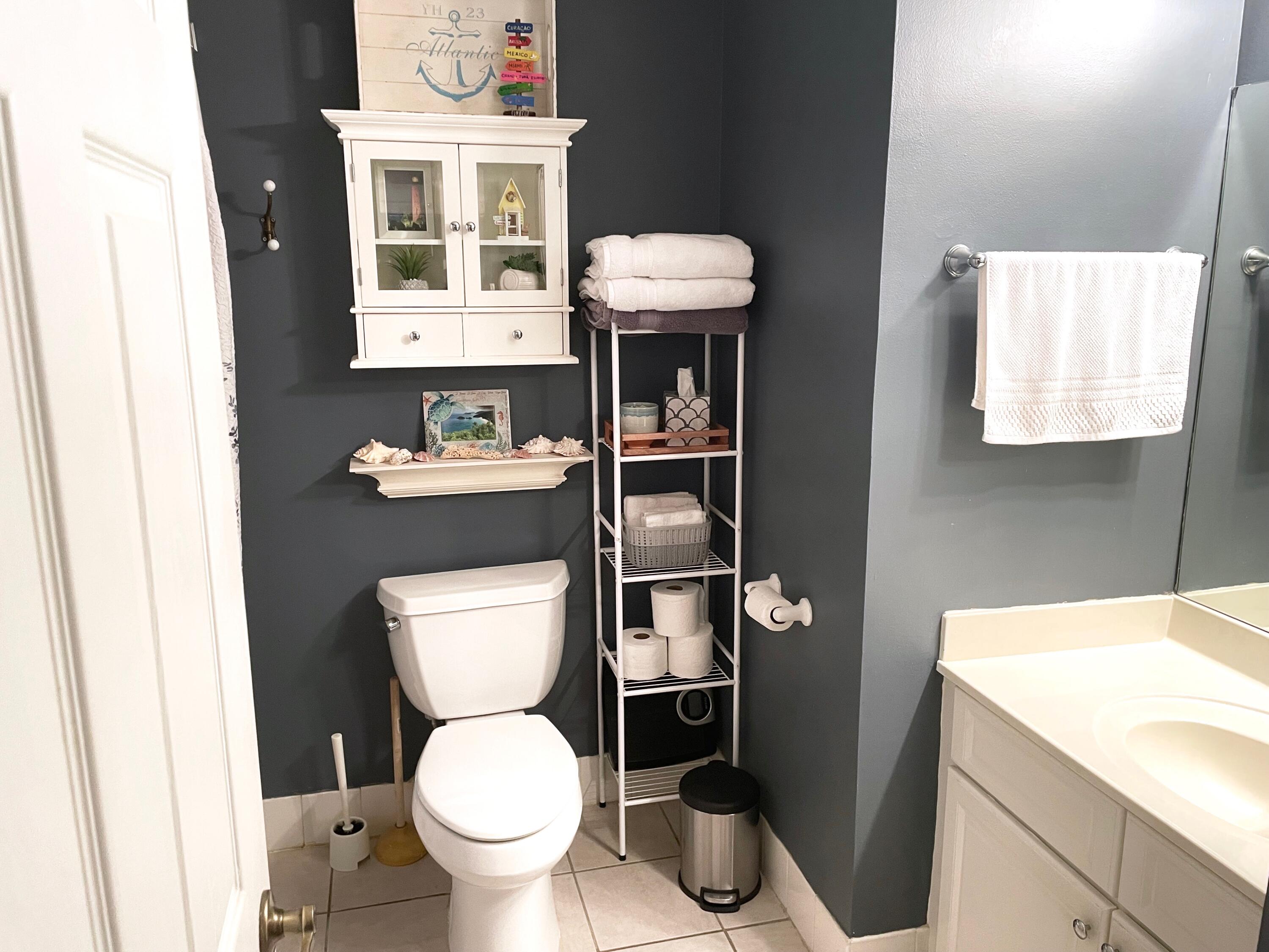 1209 Main Street, Unit 209 Jupiter, FL 33458 - Photo 7 of 14 a bathroom with a toilet a sink and a window