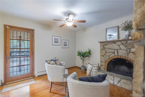 a living room with furniture a fireplace and a potted plant