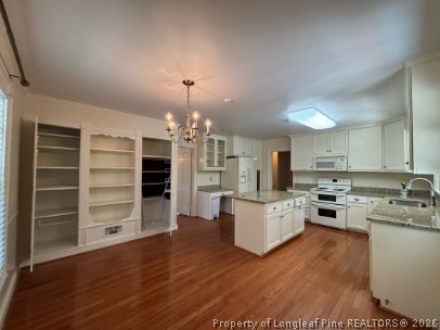 1513 Raeford Road Fayetteville, NC 28305 - Photo 7 of 25 a open kitchen with cabinets wooden floor and stainless steel appliances