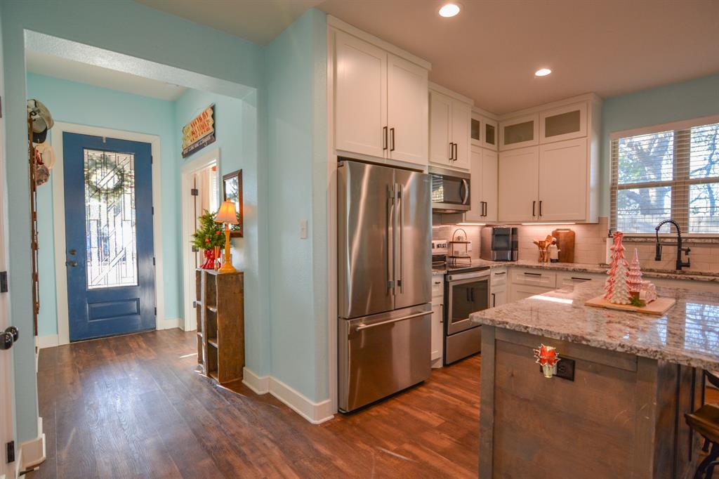 601 Mathew Street Grandview, TX 76050 - Photo 7 of 40 a kitchen with granite countertop a refrigerator and a sink