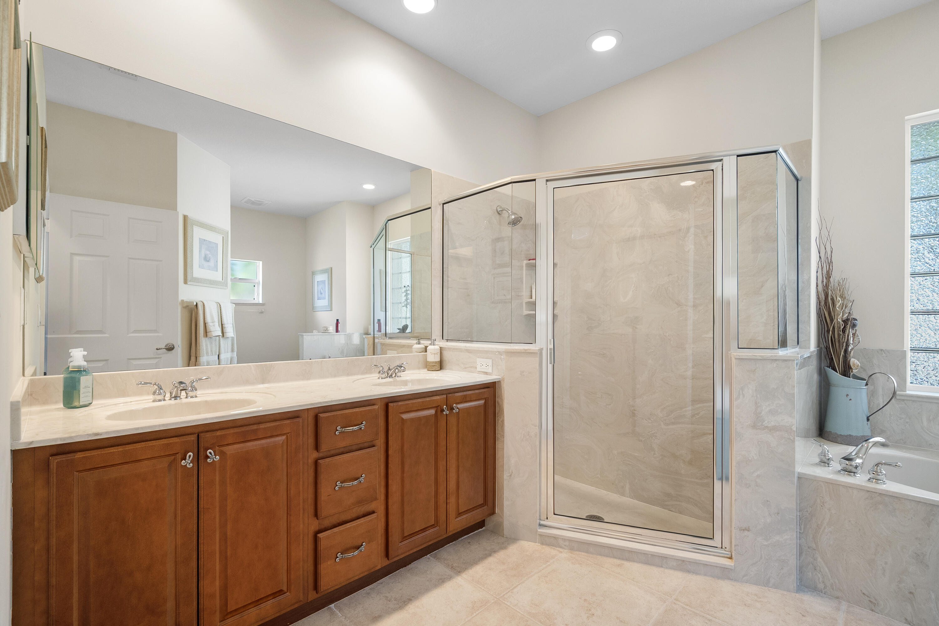 1234 Southwest Locks Road Stuart, FL 34997 - Photo 18 of 53 a bathroom with a double vanity sink mirror and shower