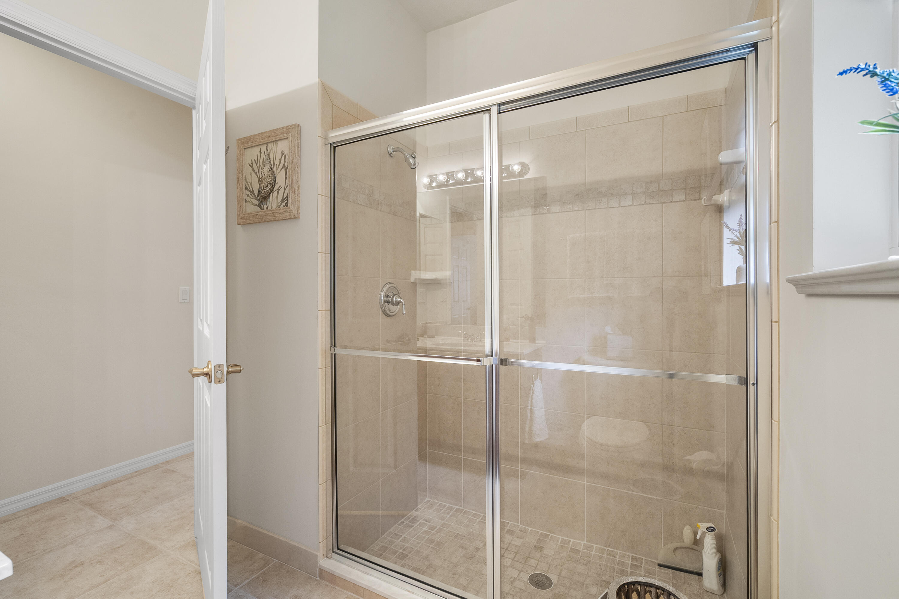 1234 Southwest Locks Road Stuart, FL 34997 - Photo 26 of 53 a bathroom with a glass shower door