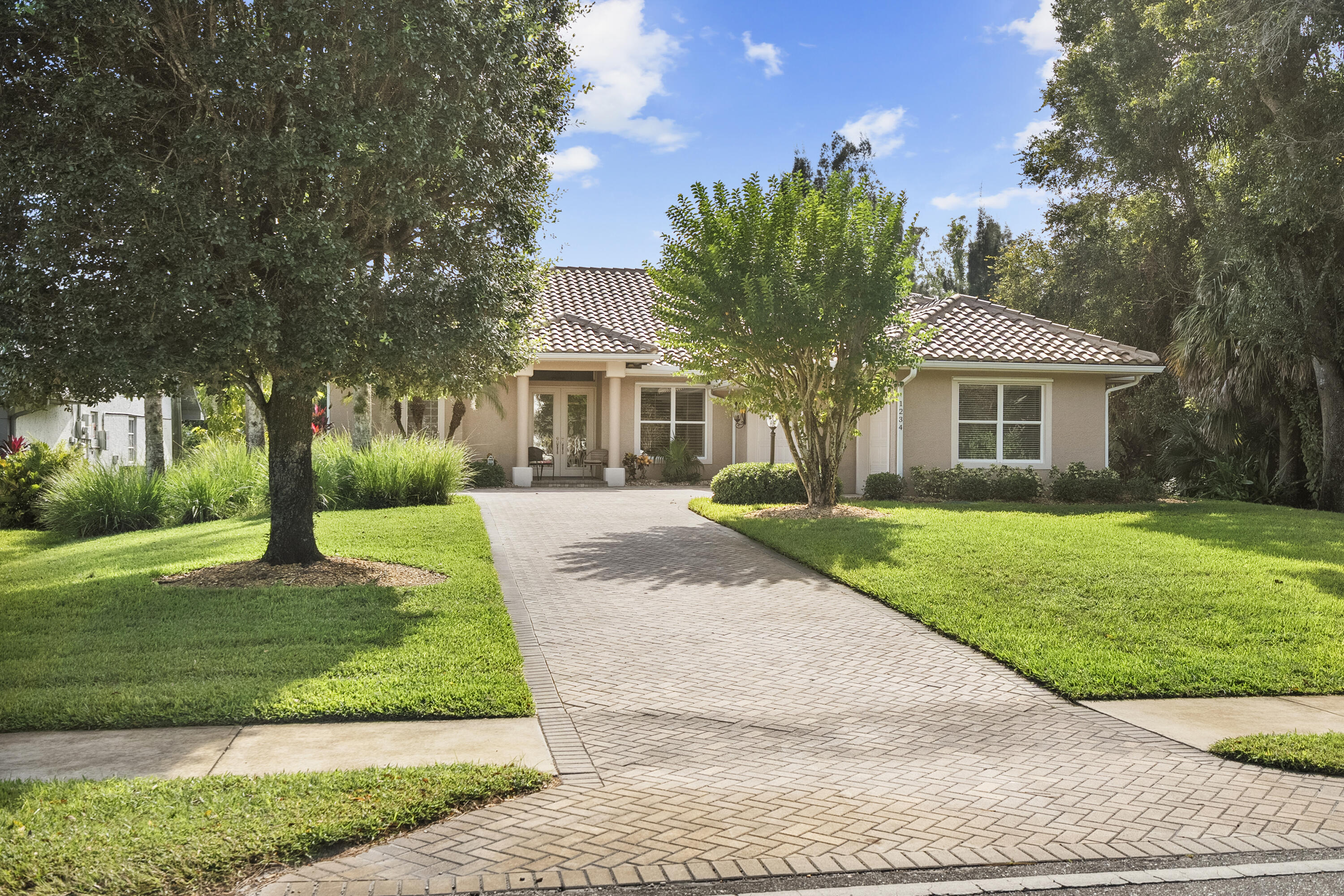 1234 Southwest Locks Road Stuart, FL 34997 - Photo 40 of 53 a front view of a house with a yard