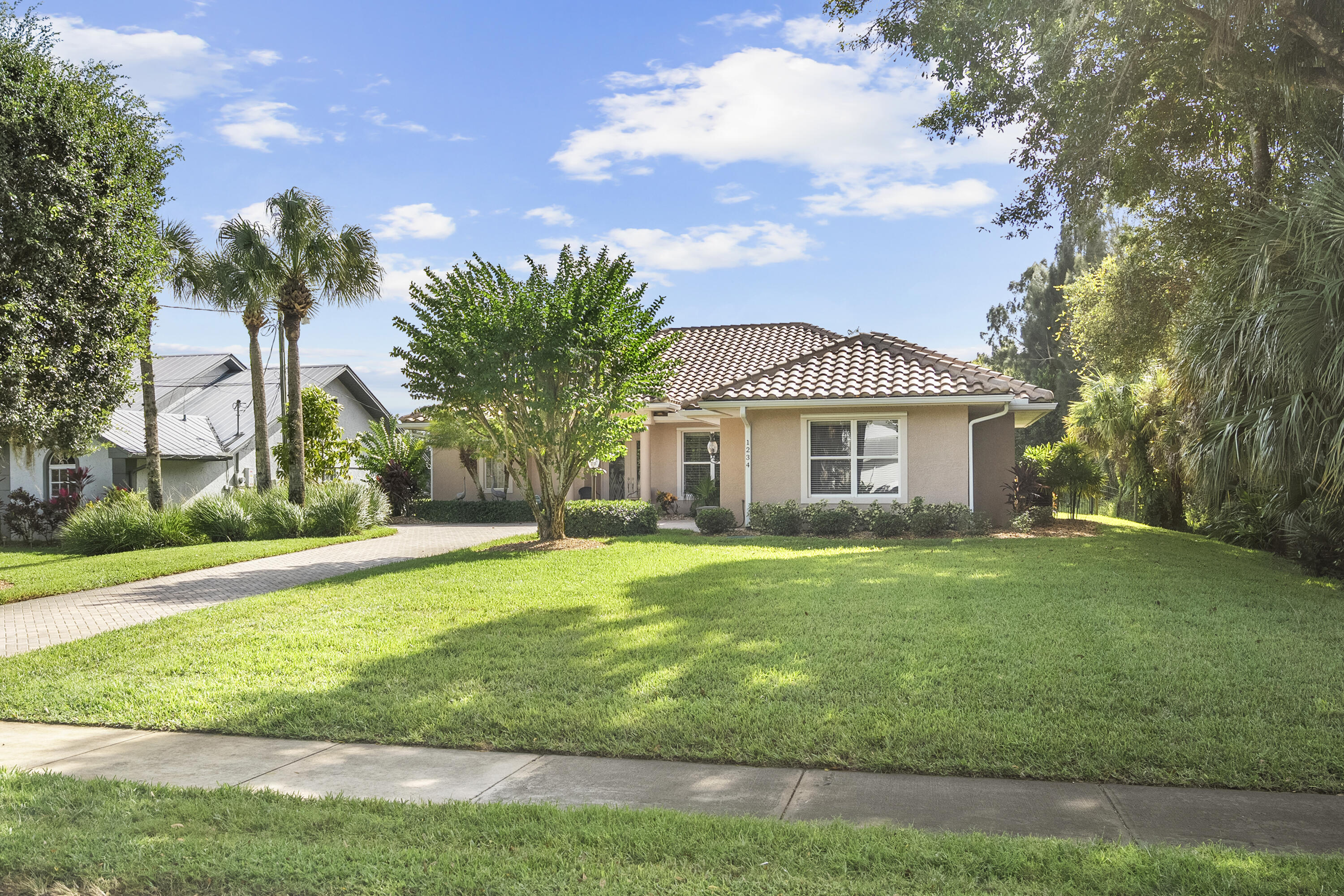 1234 Southwest Locks Road Stuart, FL 34997 - Photo 43 of 53 a front view of a house with a yard