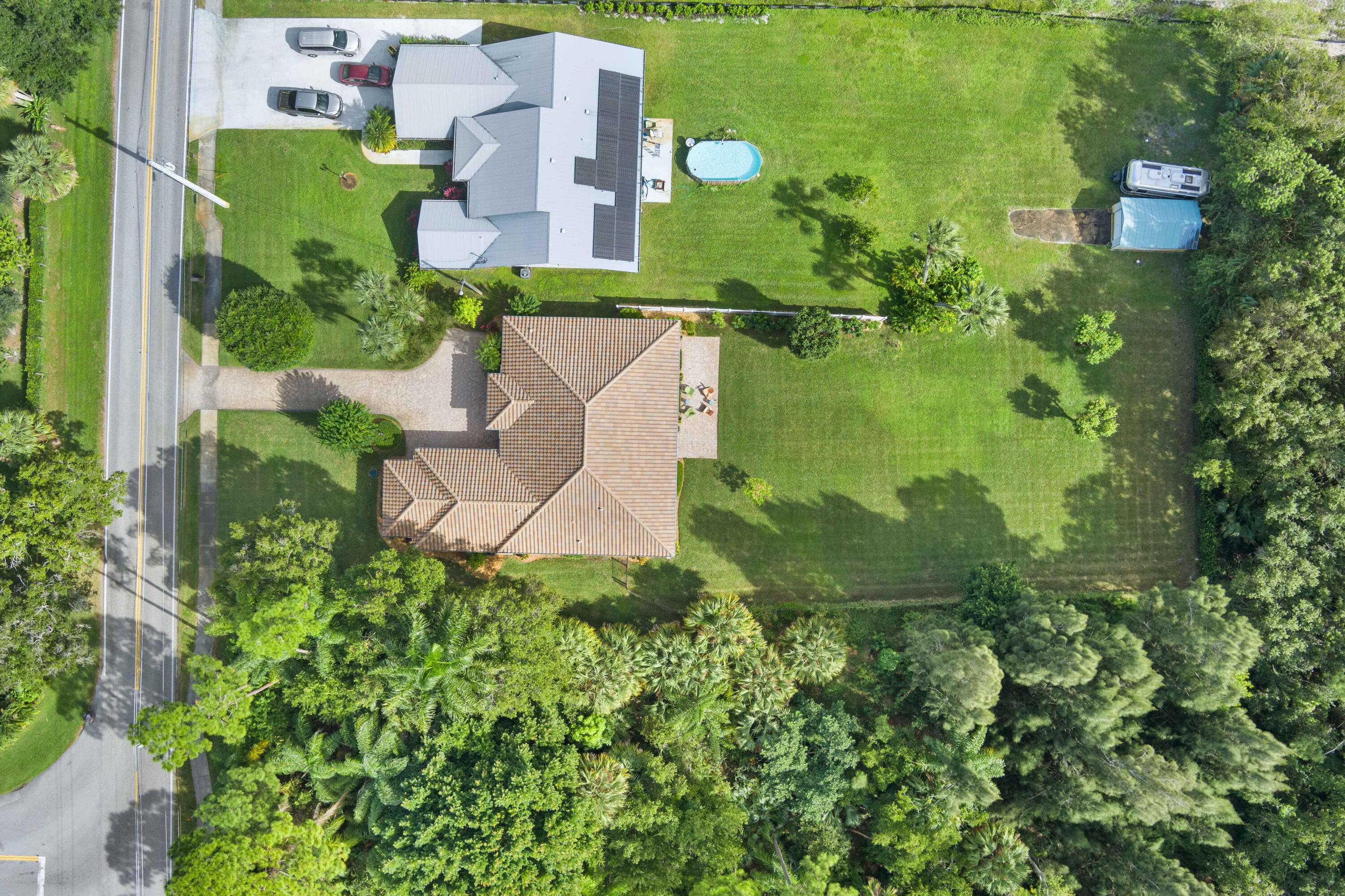 1234 Southwest Locks Road Stuart, FL 34997 - Photo 47 of 53 an aerial view of residential houses with outdoor space and trees all around