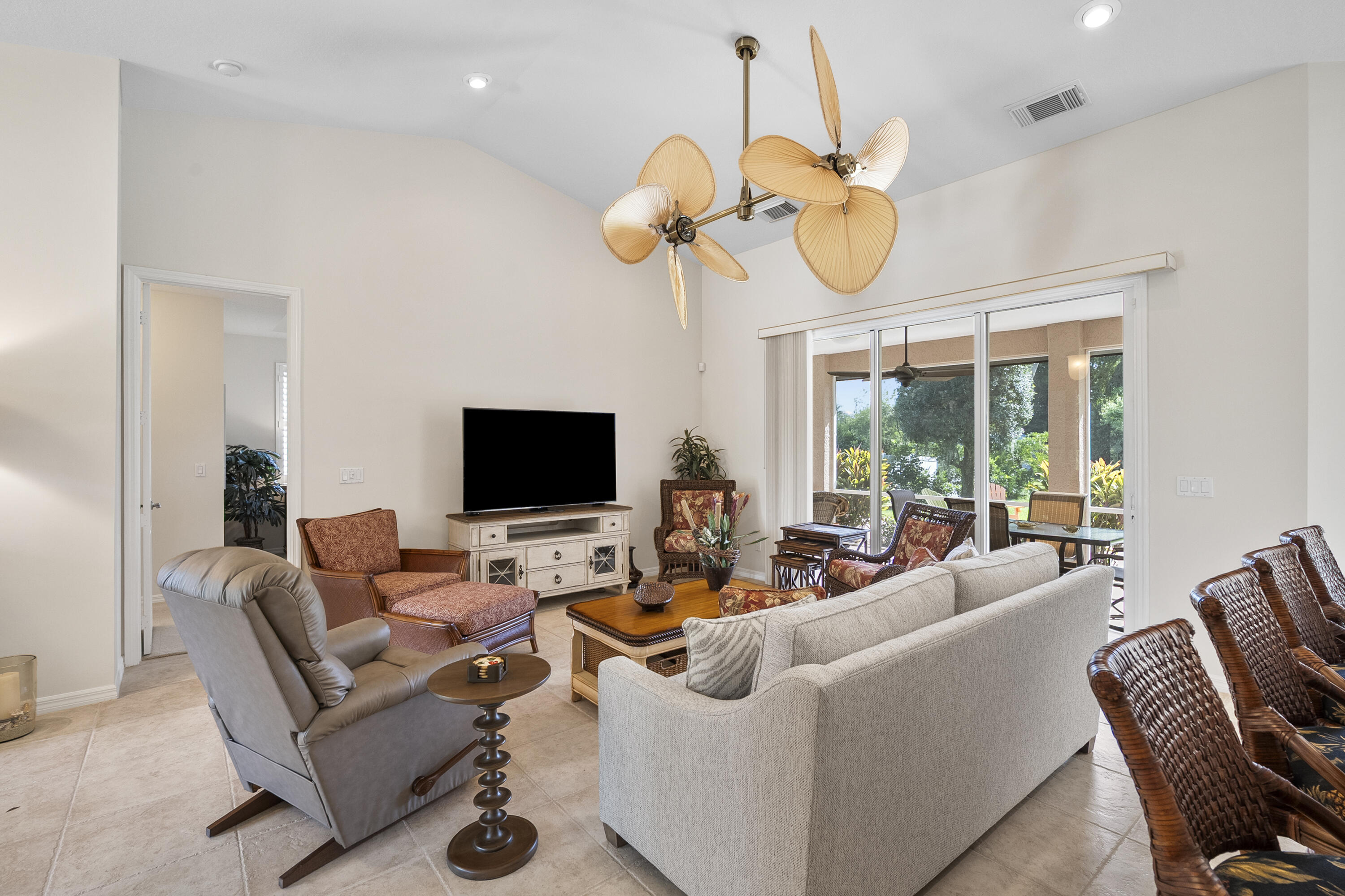 1234 Southwest Locks Road Stuart, FL 34997 - Photo 7 of 53 a living room with furniture a chandelier and a flat screen tv