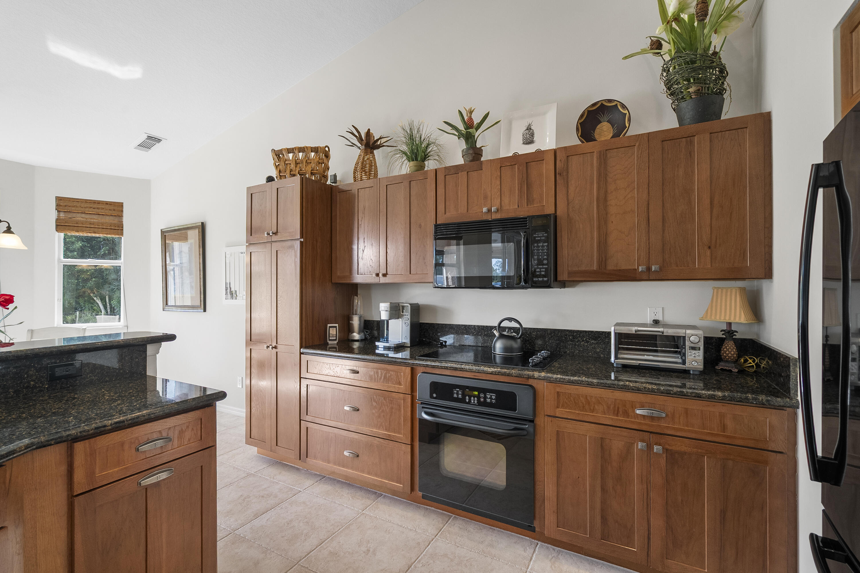 1234 Southwest Locks Road Stuart, FL 34997 - Photo 8 of 53 a kitchen with granite countertop a sink a stove and cabinets