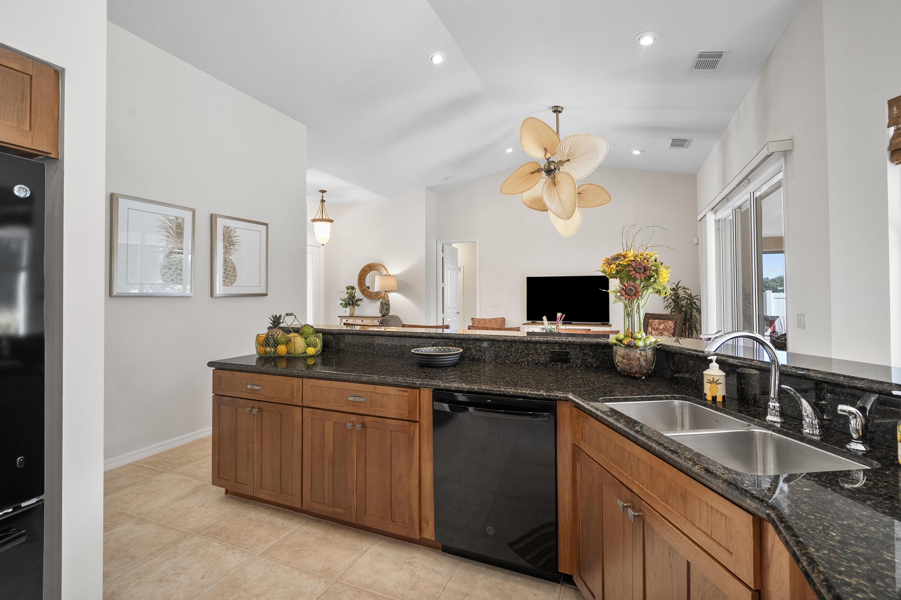 1234 Southwest Locks Road Stuart, FL 34997 - Photo 9 of 53 a kitchen with granite countertop a sink and a stove top oven with wooden floor