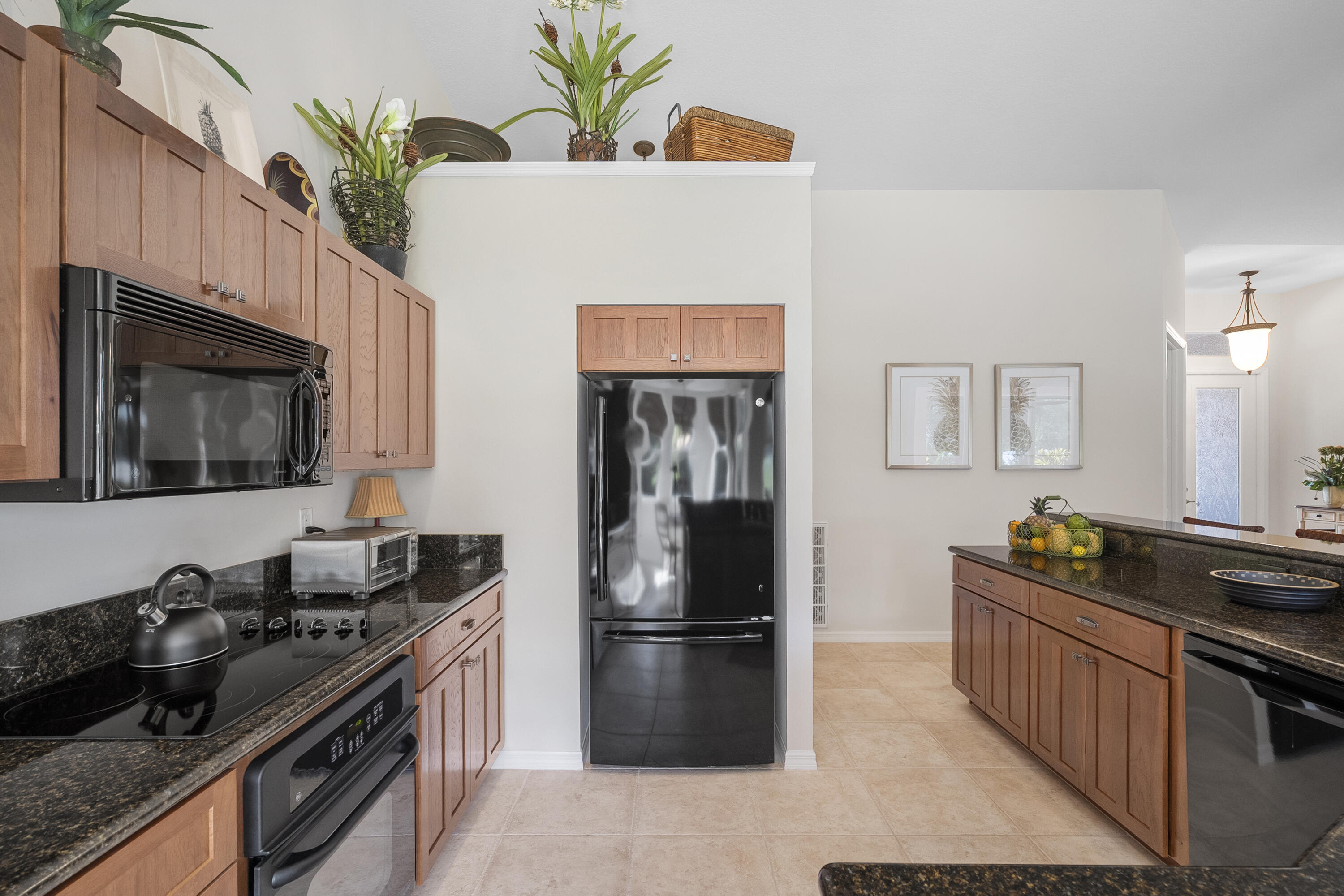 1234 Southwest Locks Road Stuart, FL 34997 - Photo 10 of 53 a kitchen with stainless steel appliances a stove a refrigerator a sink a stove and wooden floor