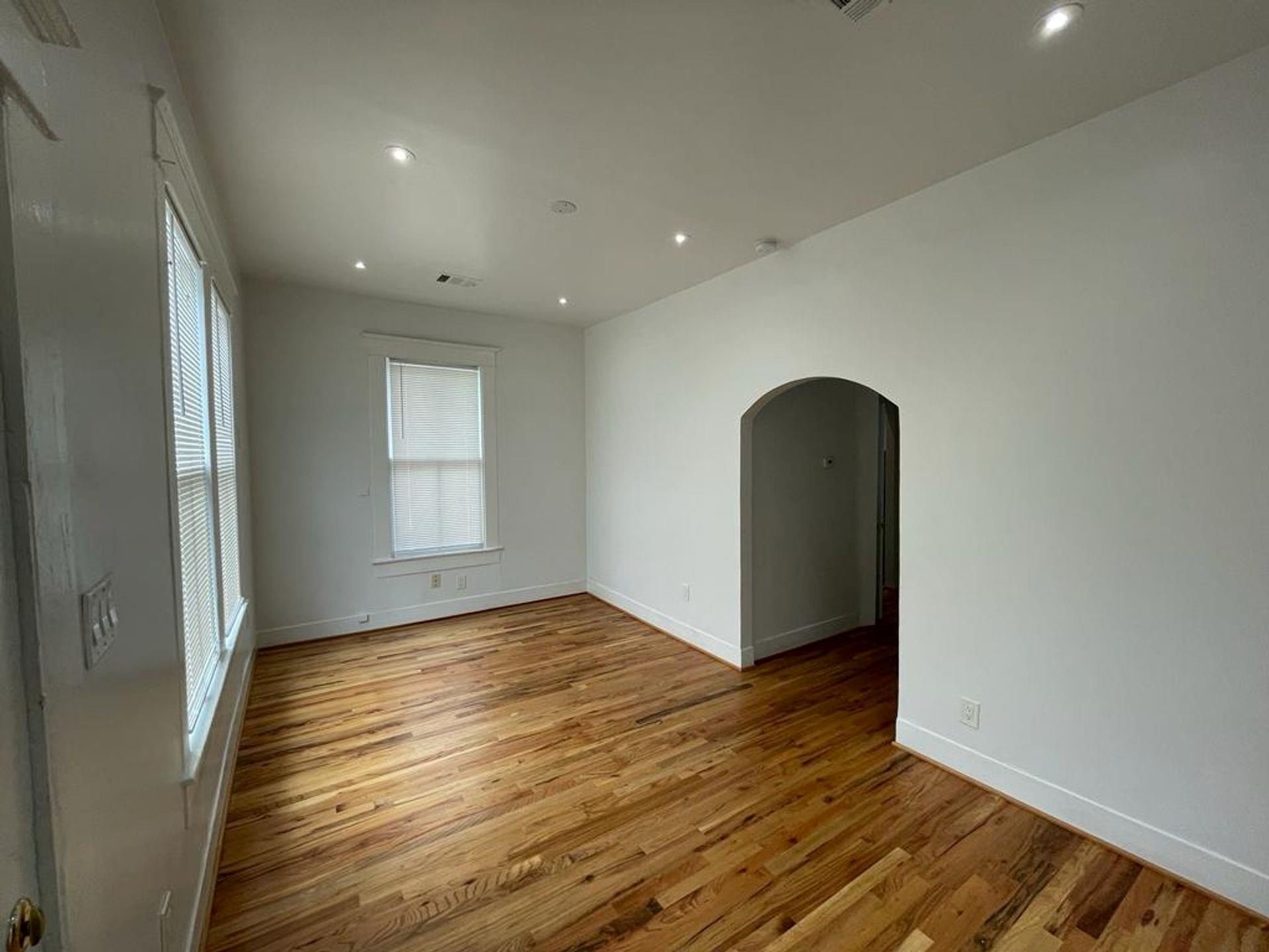 2118 Carter Street Houston, TX 77008 - Photo 2 of 8 Step into the living room with hard wood flooring, ample natural light and an archway leading you to the rest of the home