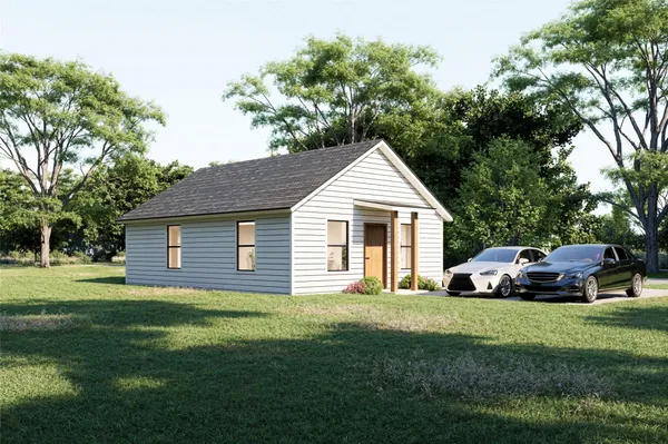 a front view of a house with a garden and trees