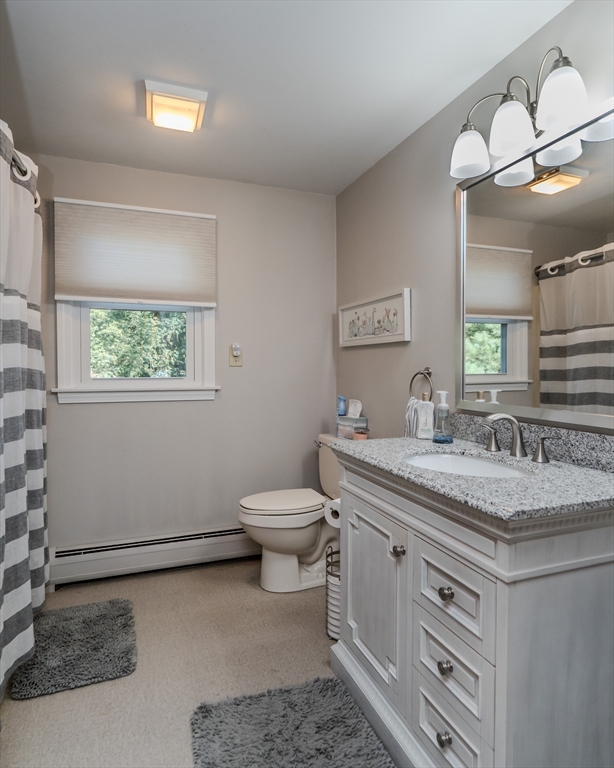 447 Ryan Road Northampton, MA 01062 - Photo 16 of 42 a spacious bathroom with a granite countertop sink toilet and mirror