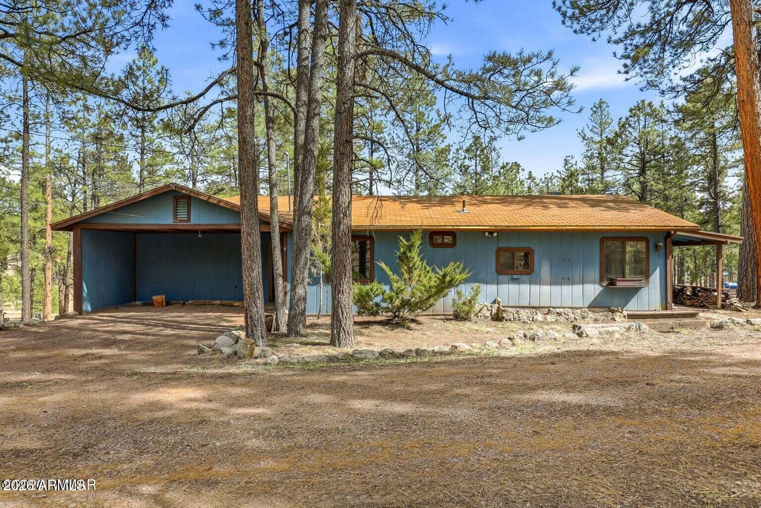 6 South County Rd N2148 Road Alpine, AZ 85920 - Photo 26 of 29 a front view of a house with a yard and garage