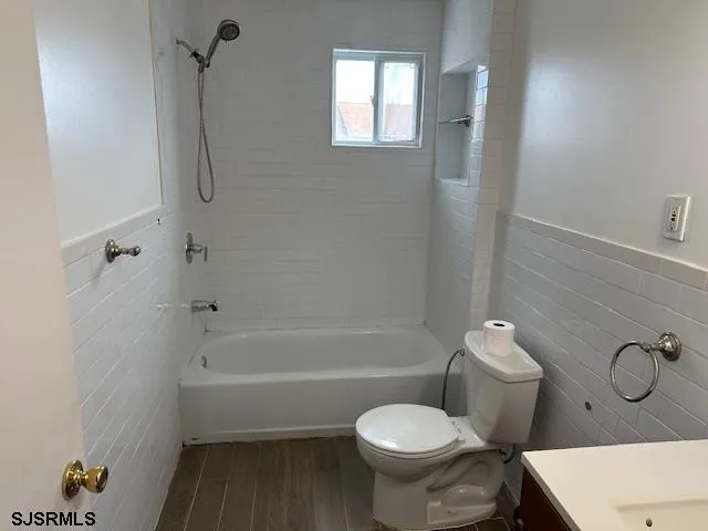 a bathroom with a toilet and a bath tub