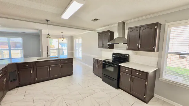 a kitchen with stainless steel appliances granite countertop a stove a sink dishwasher and a refrigerator